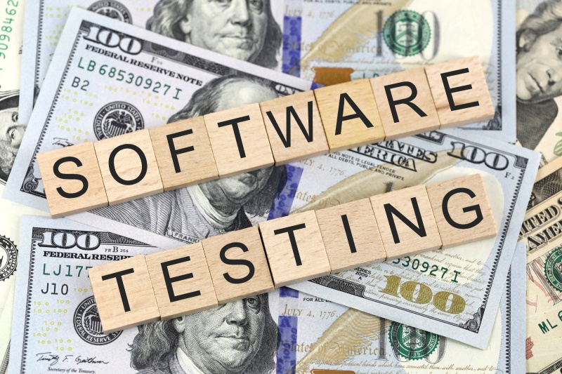 The text "software testing" on top of some bank notes